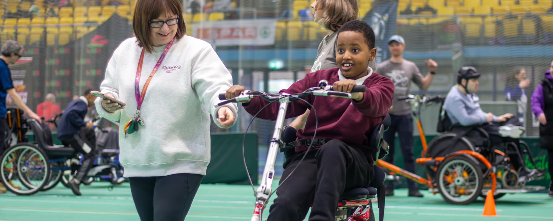 A young boy tries adapted cycling at insport Series Cardiff 2026